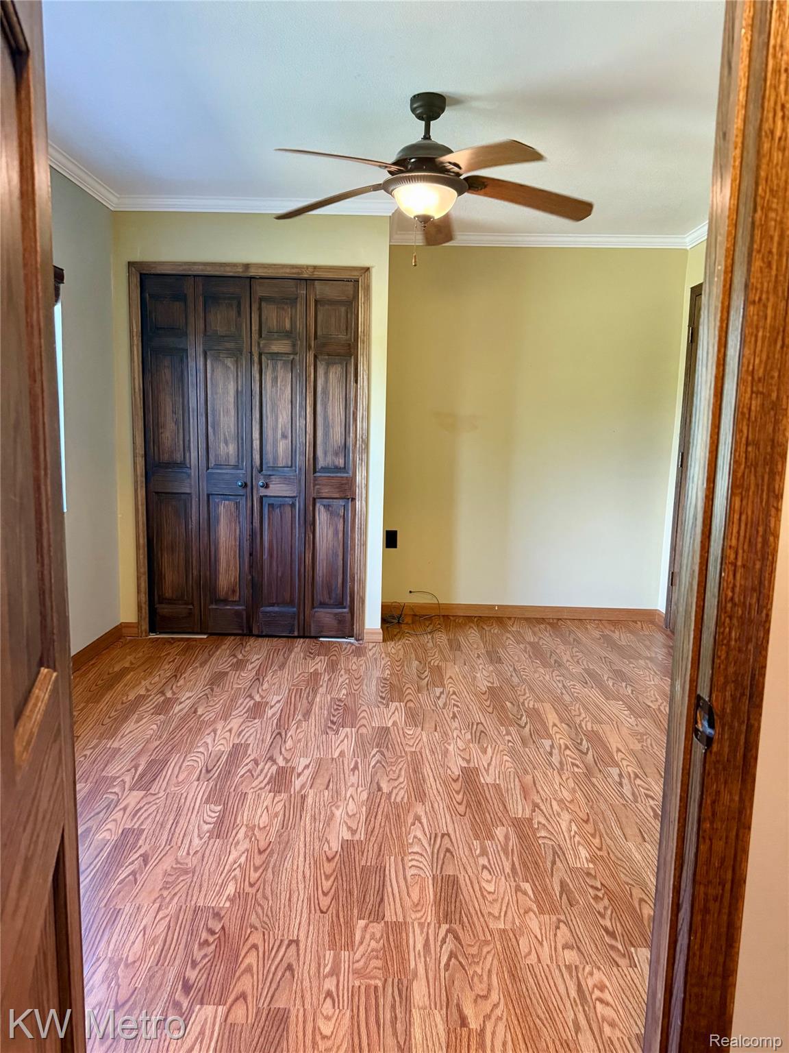 5982 South Mission Road Mount Pleasant, MI 48858 - Photo 6 of 32 Unfurnished bedroom with ornamental molding, a closet, and ceiling fan