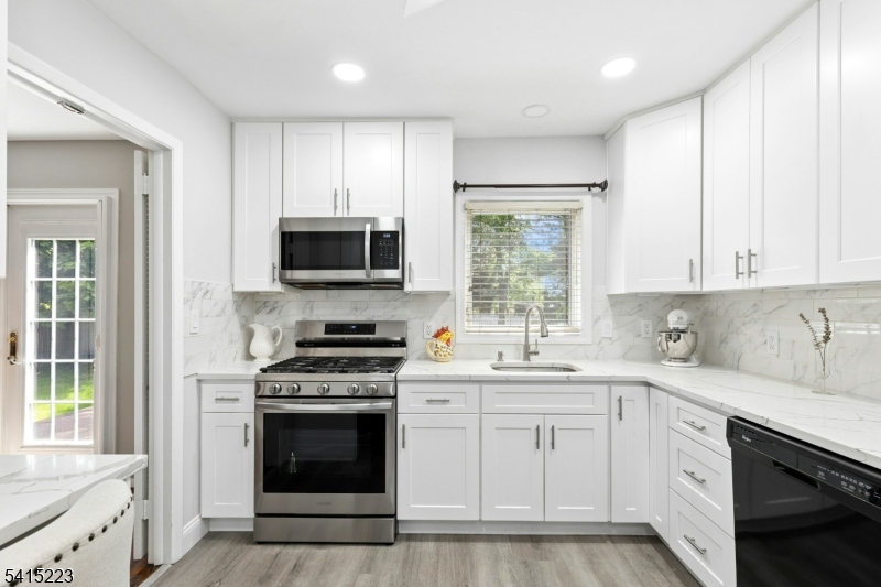 33 Carol Road Westfield, NJ 07090 - Photo 13 of 23 a kitchen with white cabinets appliances and sink