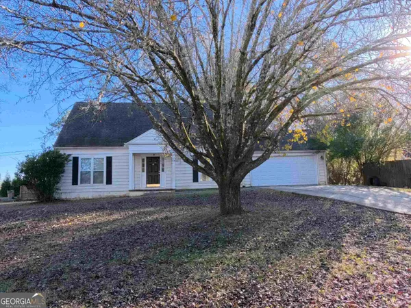 a house that has a tree in front of it