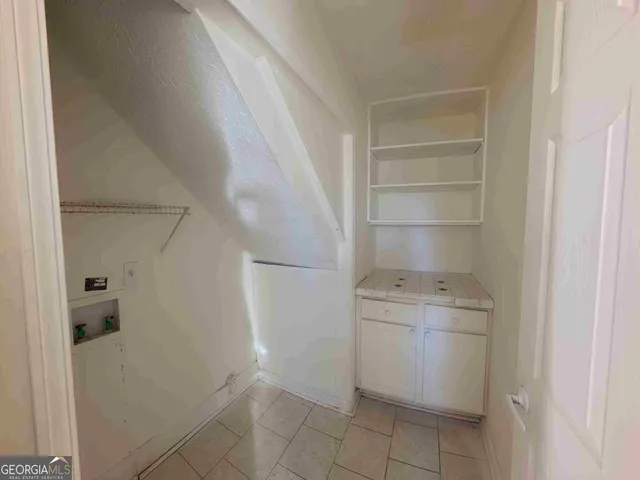 a room with a cabinets and washer dryer