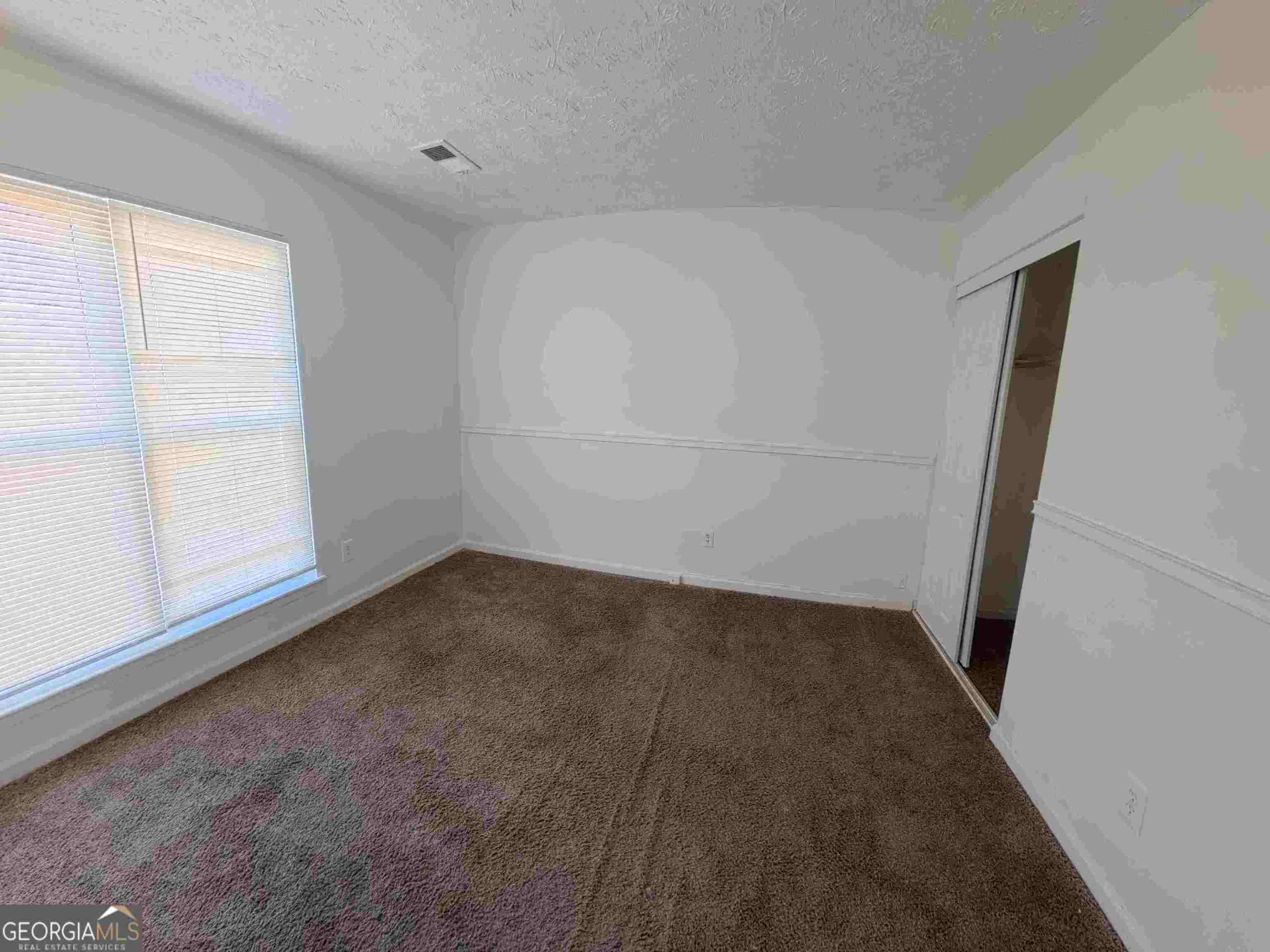 11187 Shannon Circle Hampton, GA 30228 - Photo 13 of 22 an empty room with a window