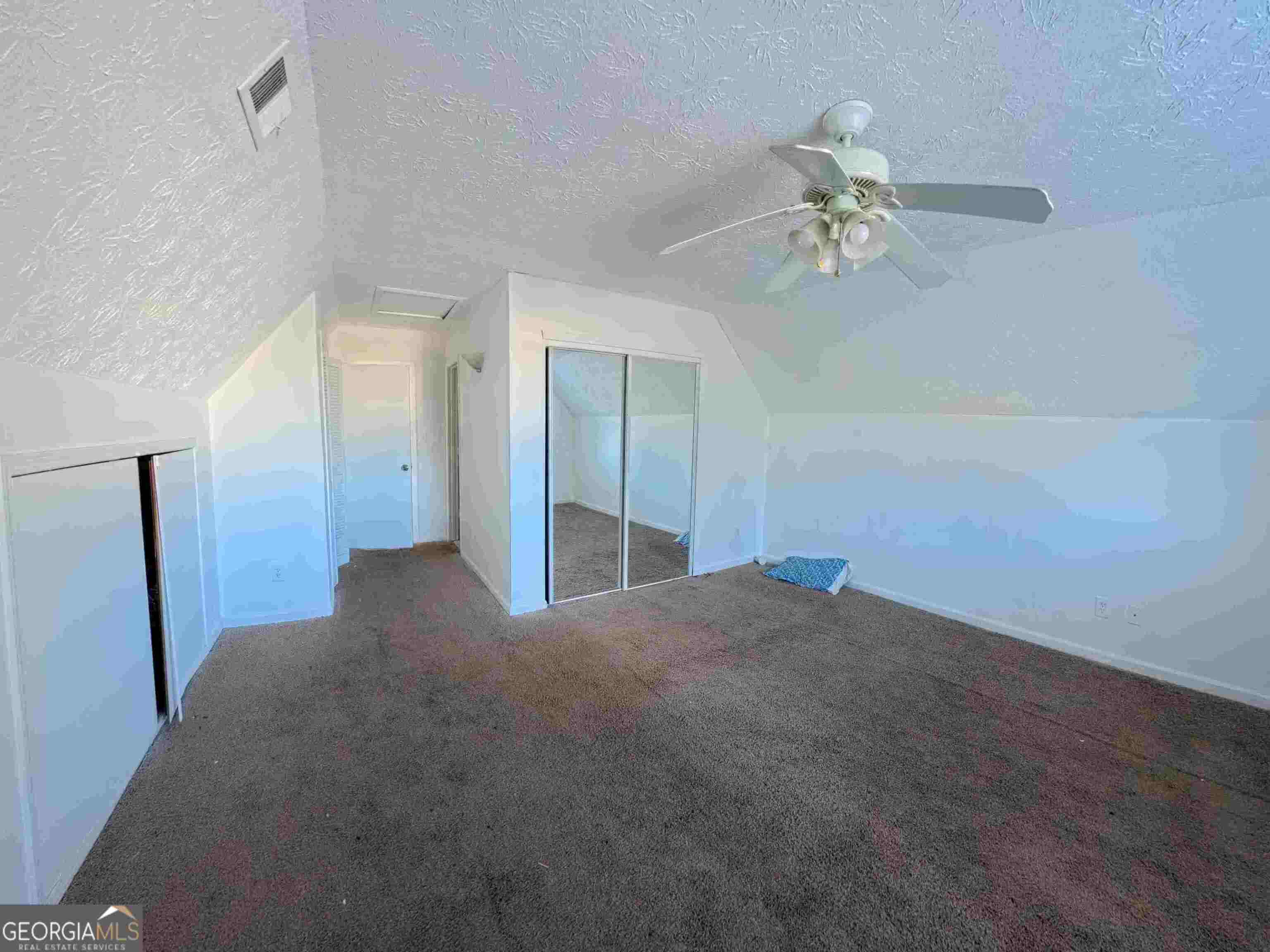 11187 Shannon Circle Hampton, GA 30228 - Photo 16 of 22 a view of a big room with chandelier fan and windows