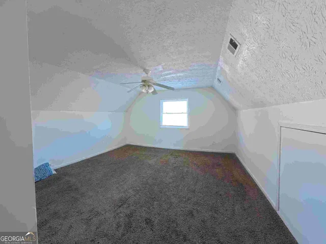 an empty room with a empty space and windows