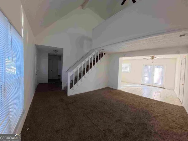 a view of an empty room with stairs