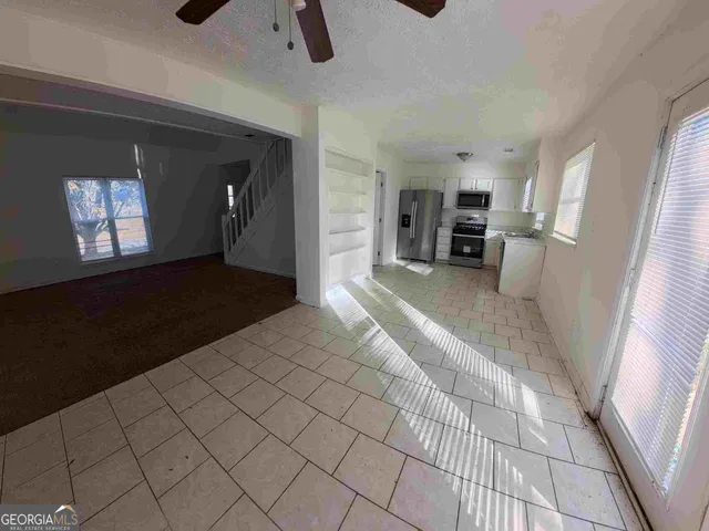 a view of a livingroom with furniture and window