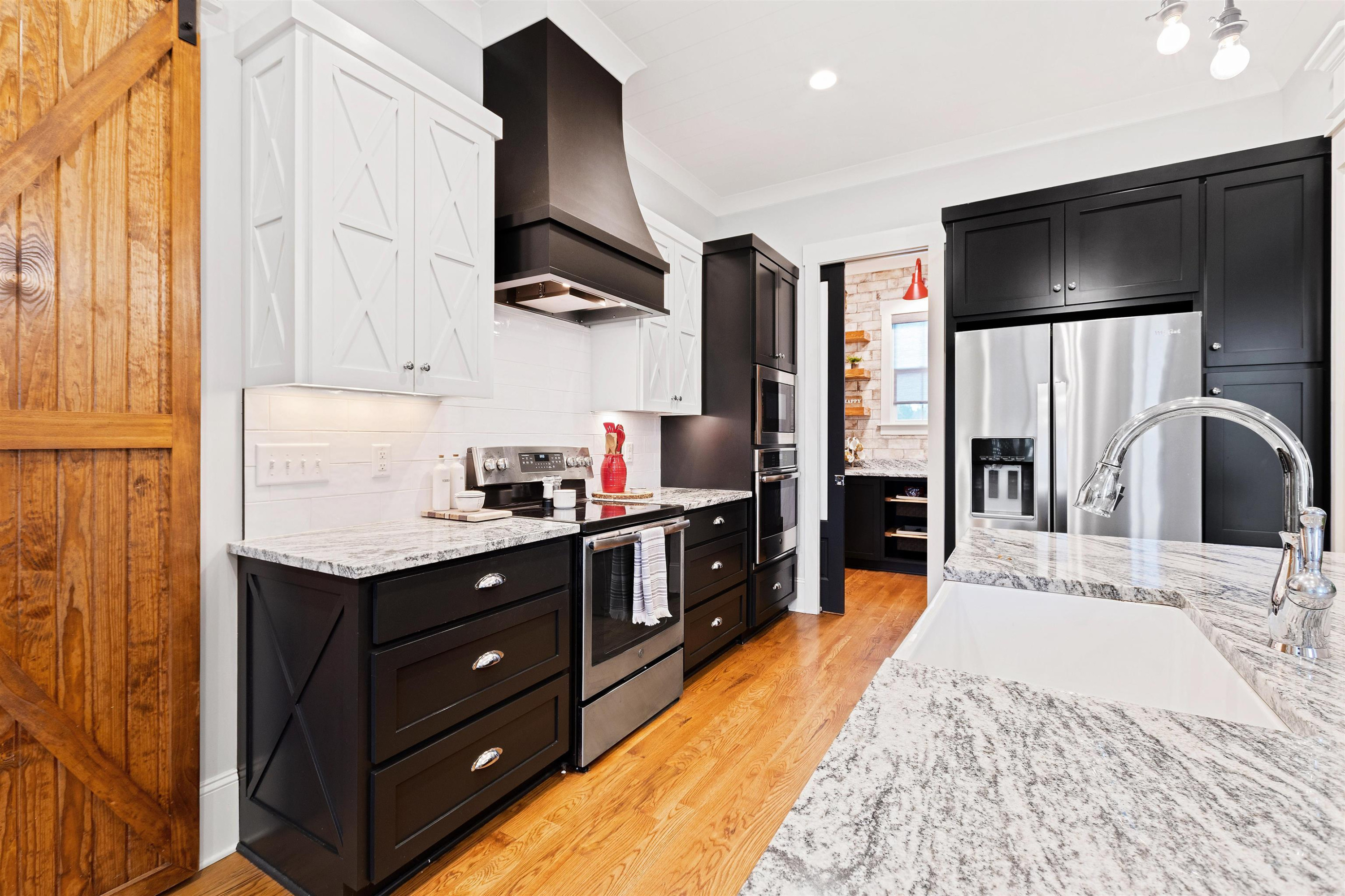 73 Constitution Avenue Smithfield, NC 27577 - Photo 29 of 66 a kitchen with stainless steel appliances kitchen island granite countertop a refrigerator and a sink