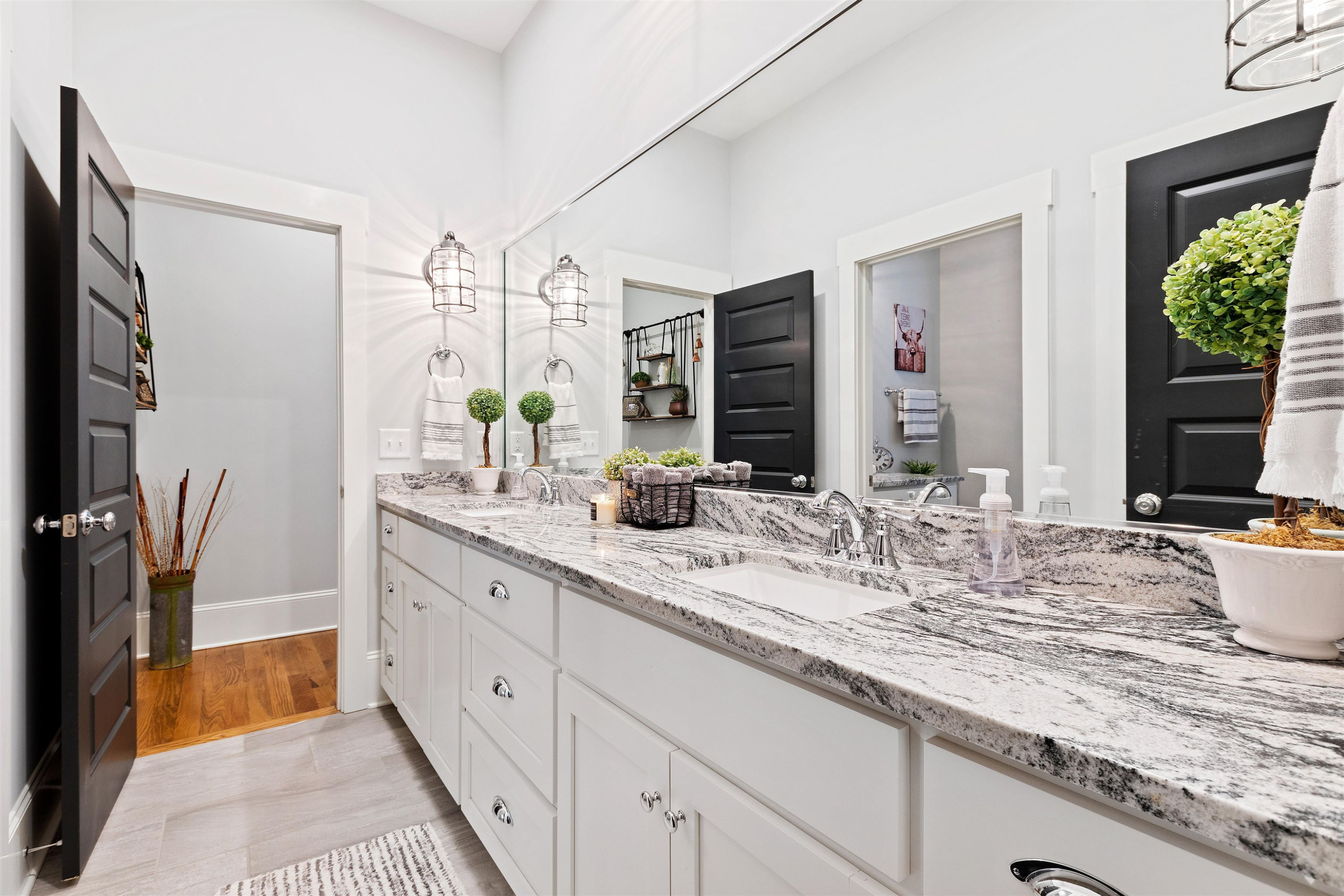 73 Constitution Avenue Smithfield, NC 27577 - Photo 36 of 66 a bathroom with a granite countertop sink and a mirror