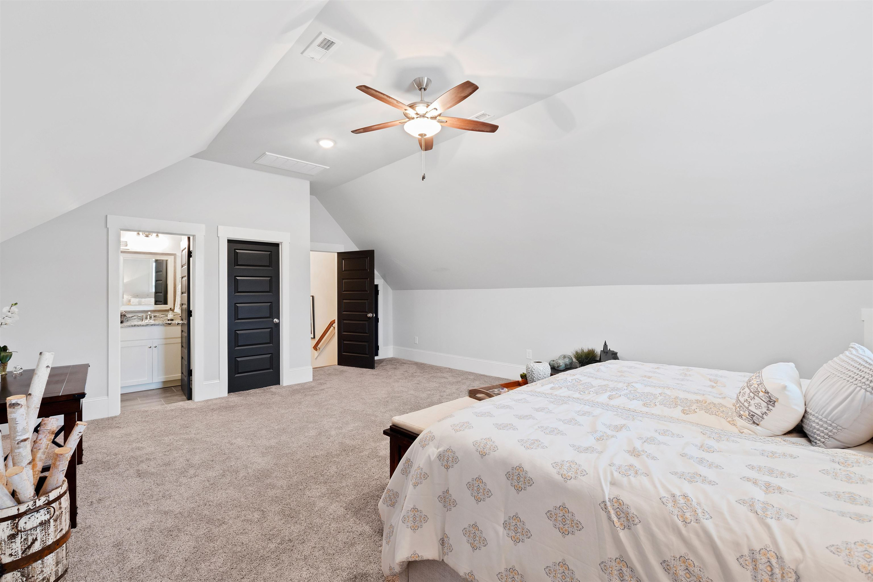 73 Constitution Avenue Smithfield, NC 27577 - Photo 53 of 66 a bedroom with a large bed and a chandelier