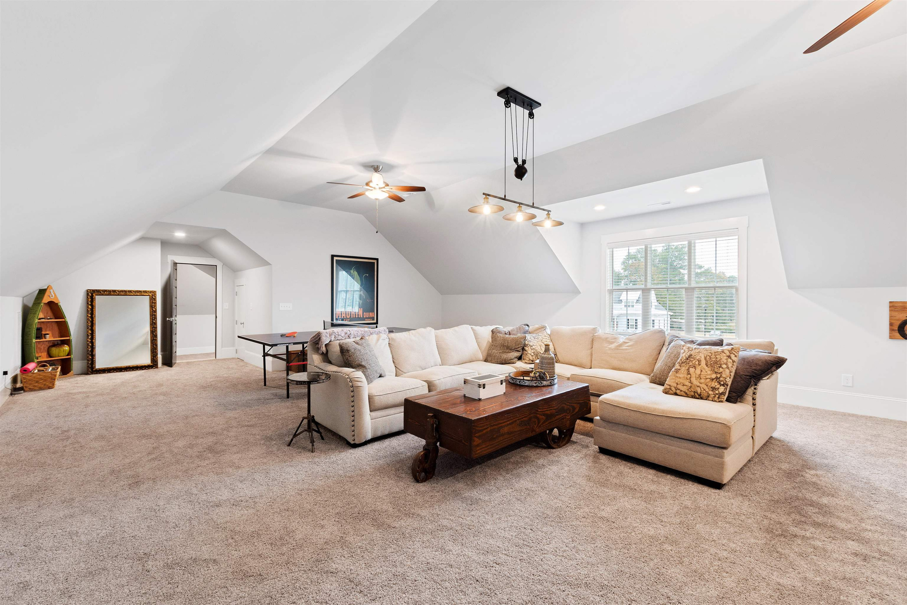 73 Constitution Avenue Smithfield, NC 27577 - Photo 55 of 66 a living room with furniture and a chandelier
