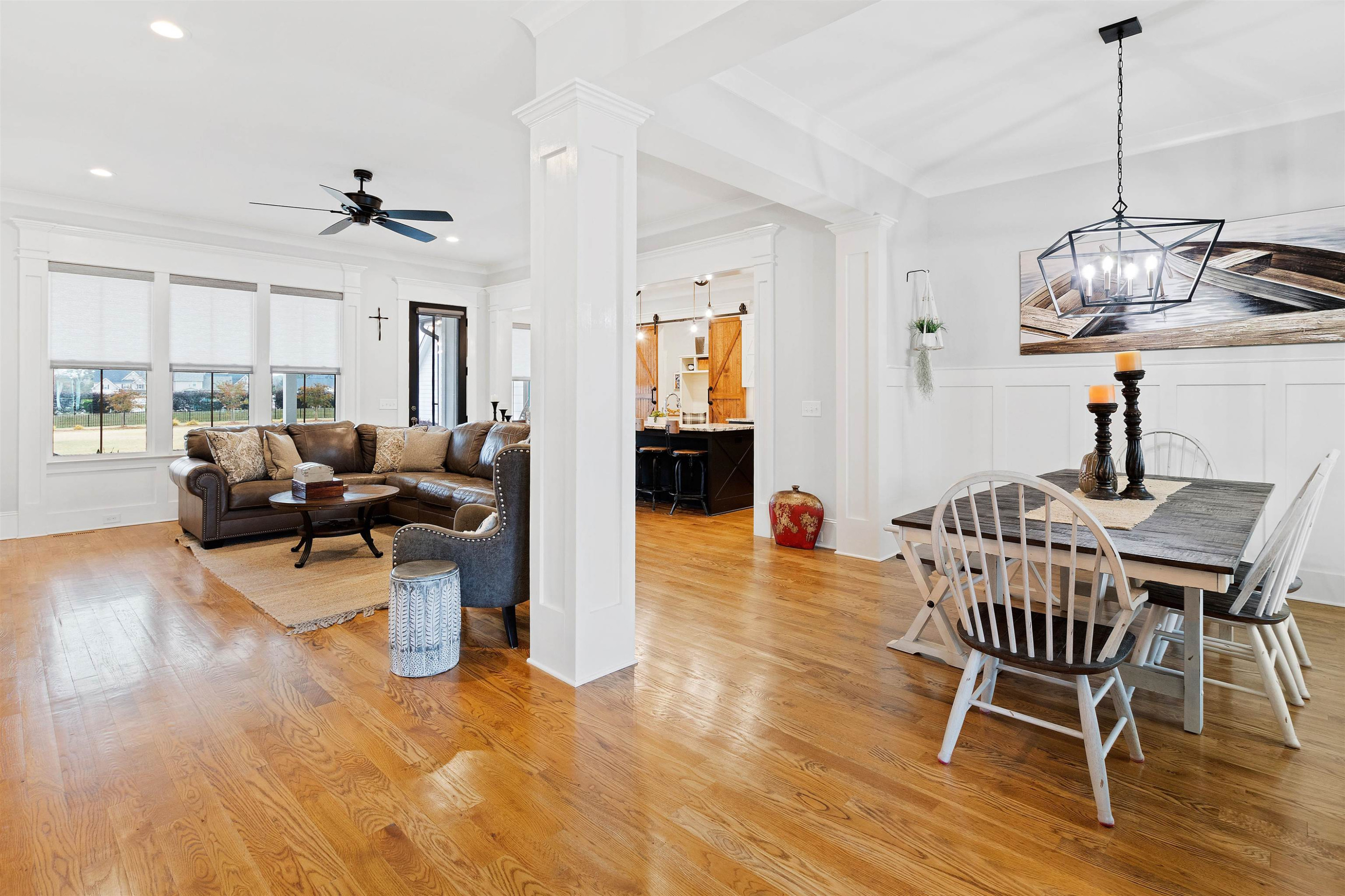 73 Constitution Avenue Smithfield, NC 27577 - Photo 6 of 66 a dining room with wooden floor a chandelier a glass table and chairs