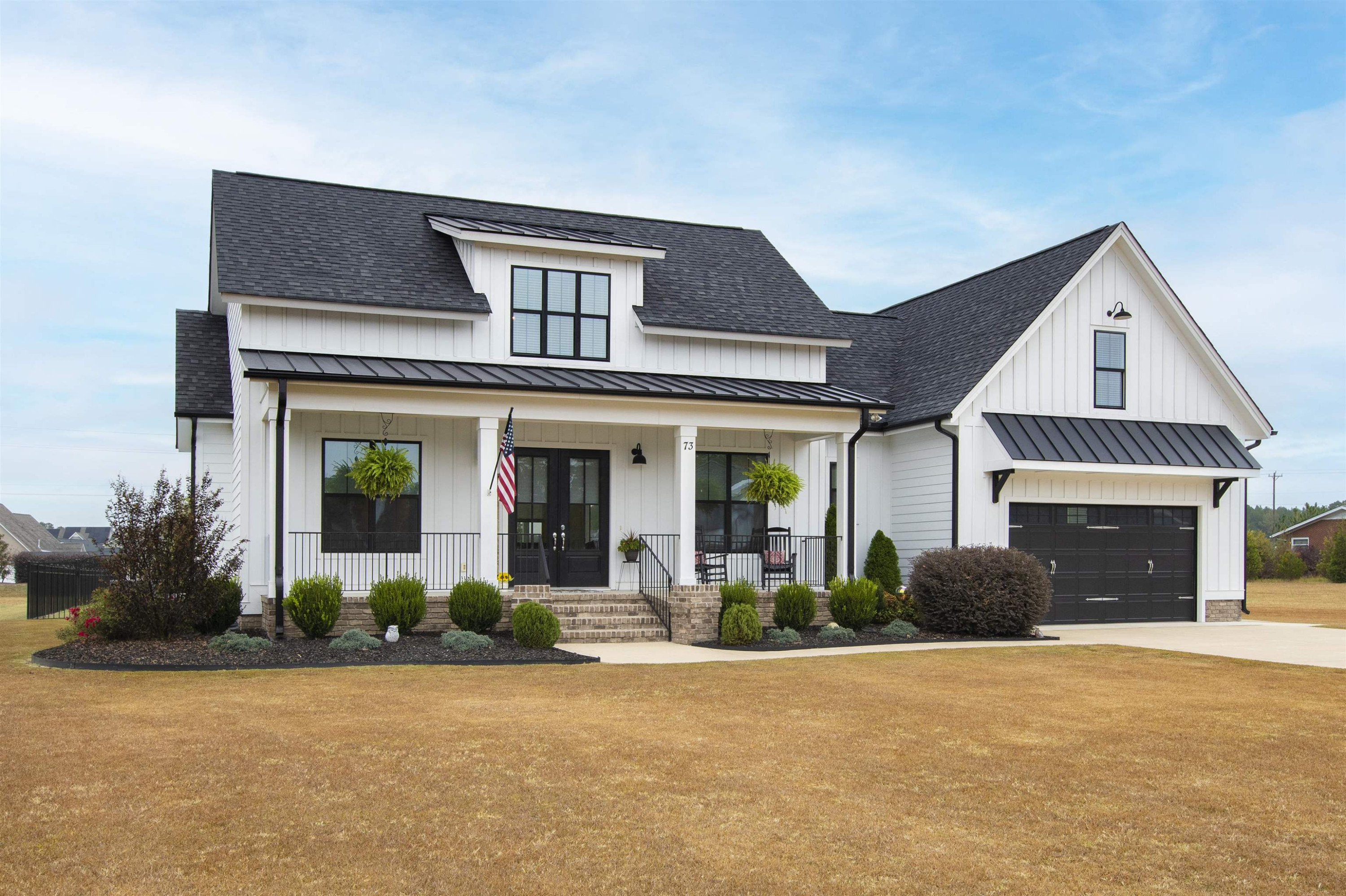 73 Constitution Avenue Smithfield, NC 27577 - Photo 64 of 66 a front view of a house with a yard and garage
