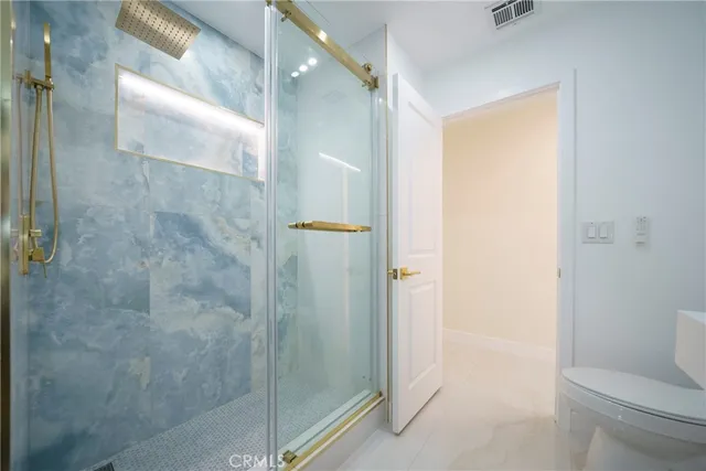 a bedroom with a bed and a chair