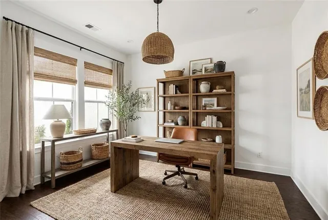 a view of a workspace with furniture and a window