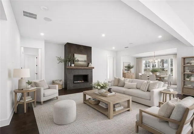 a living room with furniture a fireplace and a flat screen tv