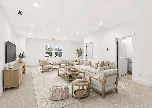 a front view of a house with a yard covered in snow