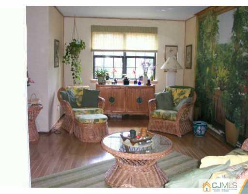 6508 Hana Road Edison, NJ 08817 - Photo 3 of 8 a living room with furniture and a large window