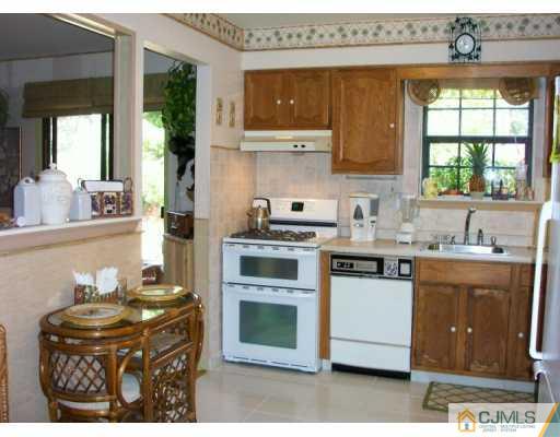 6508 Hana Road Edison, NJ 08817 - Photo 5 of 8 a kitchen with a stove a sink and a microwave