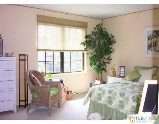 6508 Hana Road Edison, NJ 08817 - Photo 6 of 8 a bedroom with a bed and a window