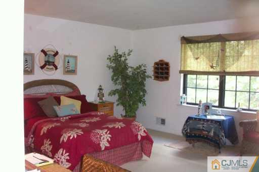 6508 Hana Road Edison, NJ 08817 - Photo 7 of 8 a bedroom with a bed and a window