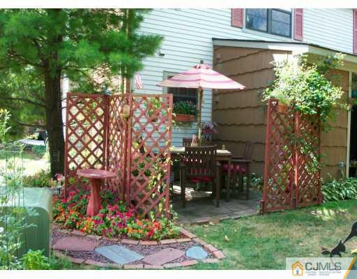 6508 Hana Road Edison, NJ 08817 - Photo 8 of 8 a view of a cafe with a table and chairs under an umbrella