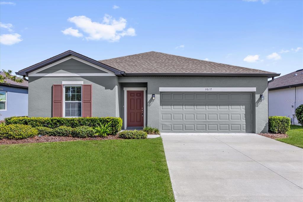 1017 Alabaster Way Deltona, FL 32725 - Photo 1 of 1 a front view of a house with a yard and garage