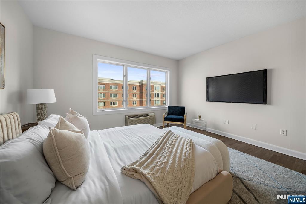 6404 City Place Edgewater, NJ 07020 - Photo 9 of 22 a bedroom with a bed and a flat screen tv