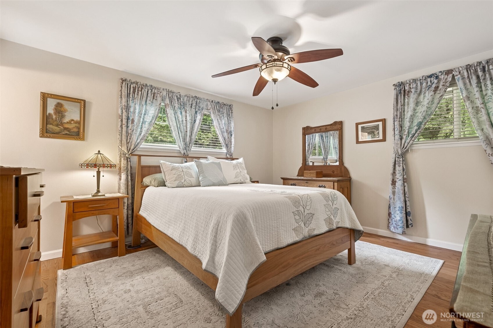 20623 98th Place South Kent, WA 98031 - Photo 13 of 37 a spacious bedroom with a large bed and a chandelier