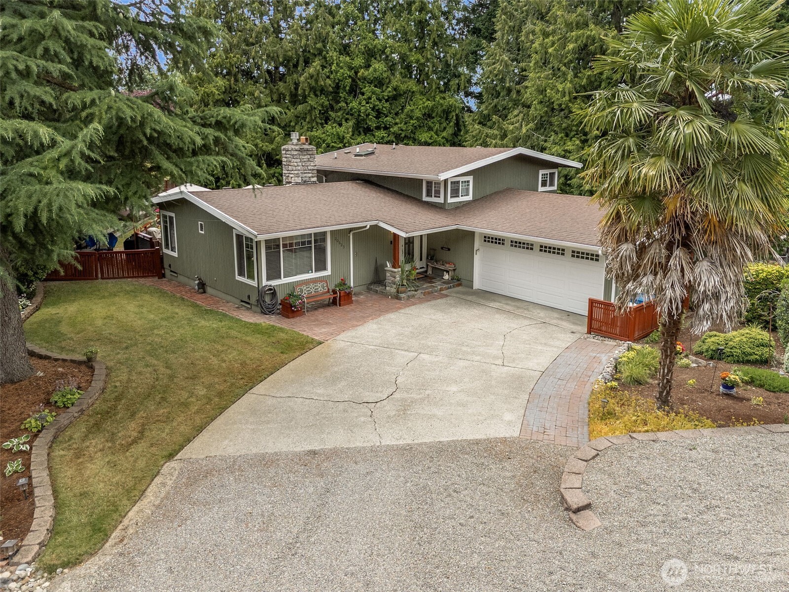 20623 98th Place South Kent, WA 98031 - Photo 3 of 37 a front view of a house with a yard and garage