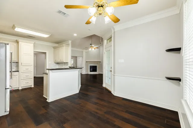 a view of a kitchen with wooden floor and a window