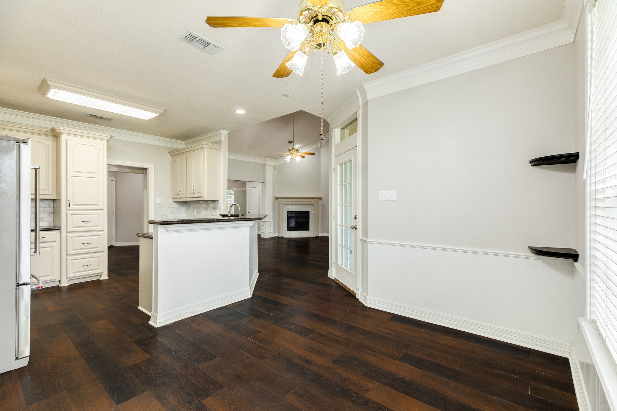 900 Enchanted Oaks Drive Angleton, TX 77515 - Photo 13 of 36 a view of a kitchen with wooden floor and a window