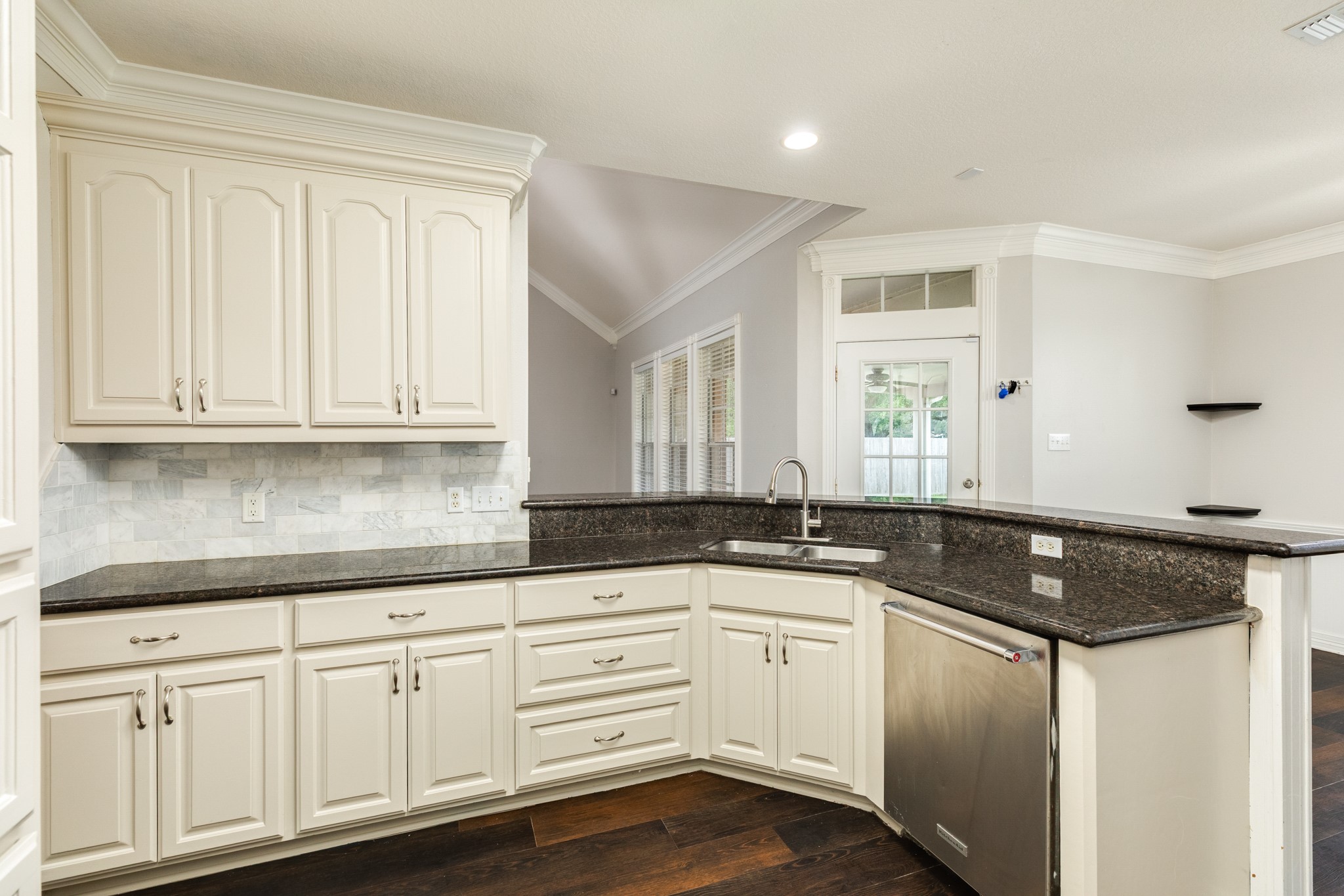 900 Enchanted Oaks Drive Angleton, TX 77515 - Photo 16 of 36 a kitchen with granite countertop white cabinets and a sink