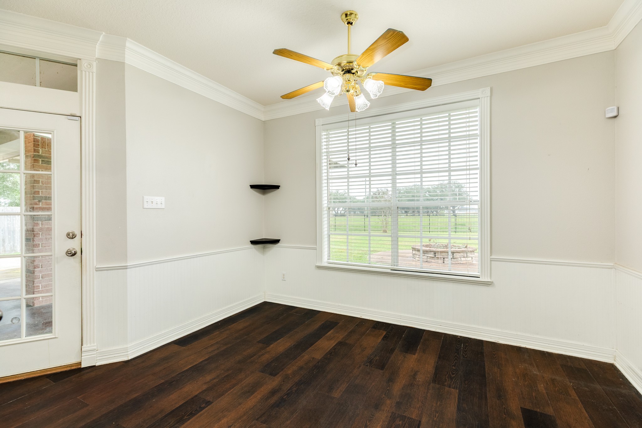900 Enchanted Oaks Drive Angleton, TX 77515 - Photo 17 of 36 an empty room with wooden floor and windows