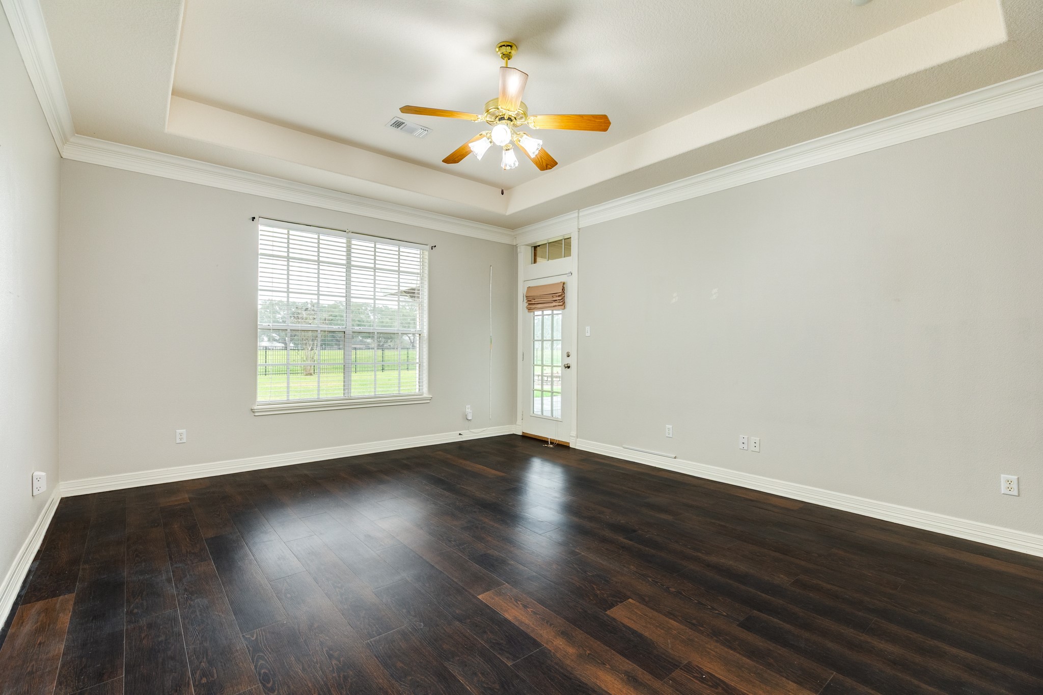 900 Enchanted Oaks Drive Angleton, TX 77515 - Photo 18 of 36 a view of an empty room with wooden floor and a chandelier