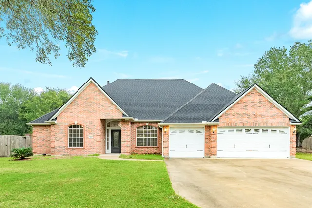 a view of a house with a yard and garage