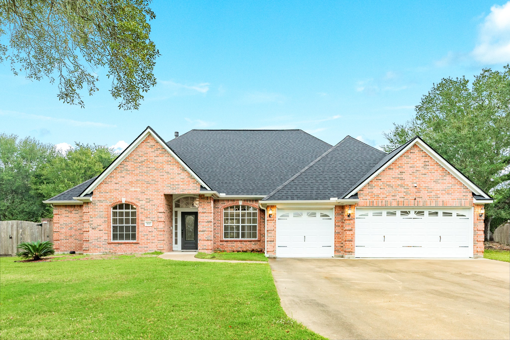 900 Enchanted Oaks Drive Angleton, TX 77515 - Photo 2 of 36 a view of a house with a yard and garage
