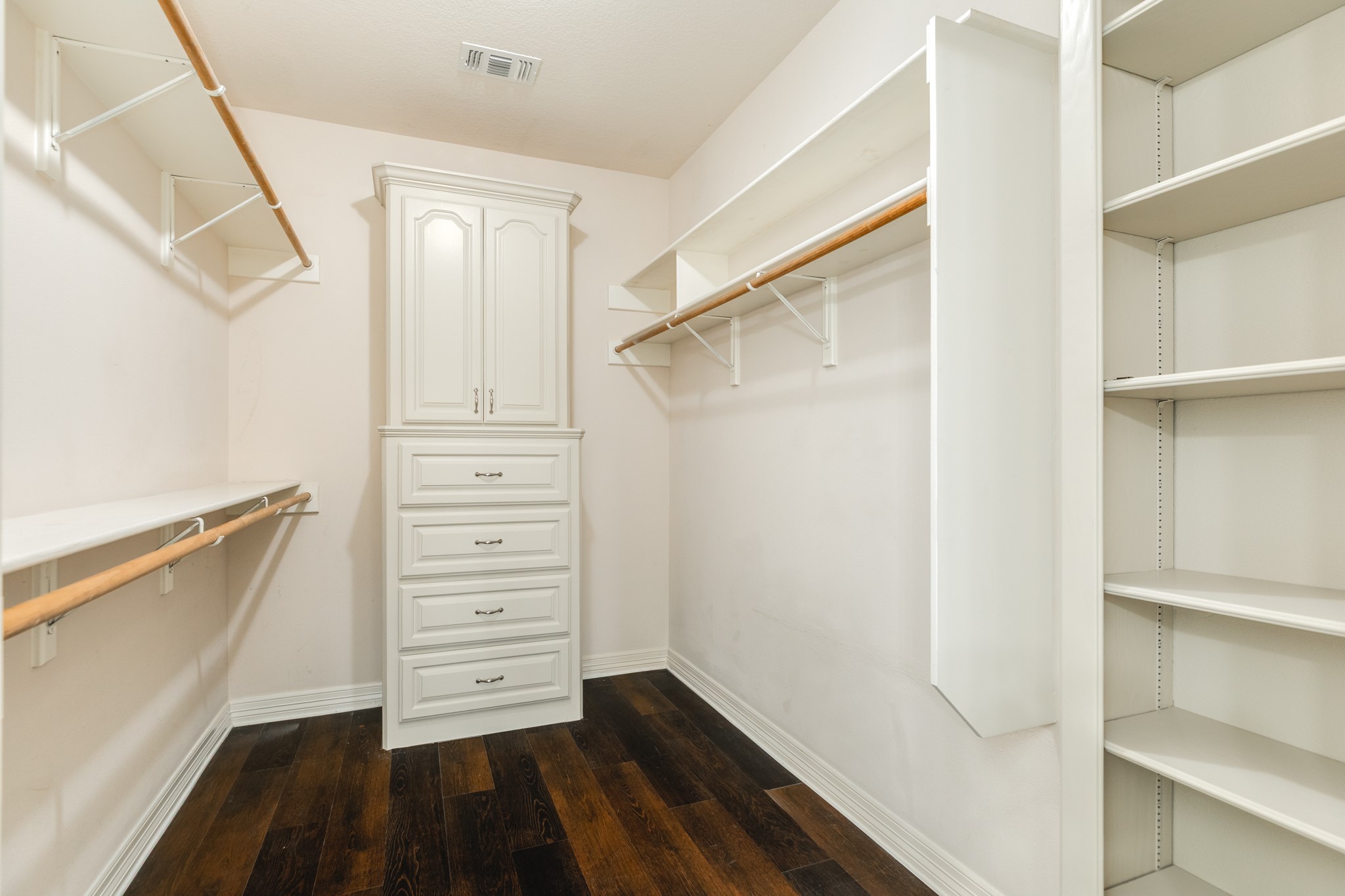 900 Enchanted Oaks Drive Angleton, TX 77515 - Photo 22 of 36 a view of walk in closet with empty racks