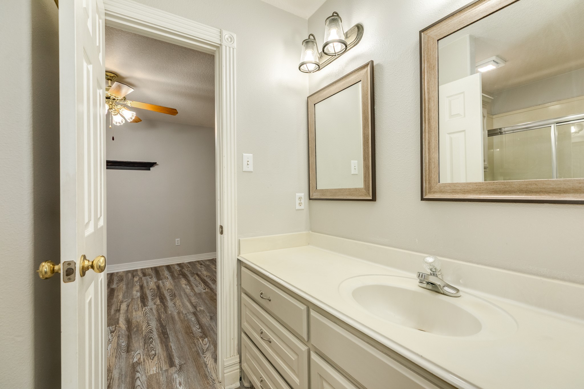 900 Enchanted Oaks Drive Angleton, TX 77515 - Photo 26 of 36 a bathroom with a sink and mirror