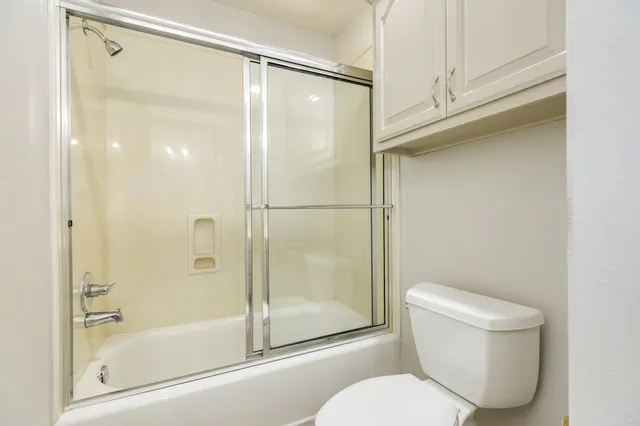 a bathroom with a shower and a toilet
