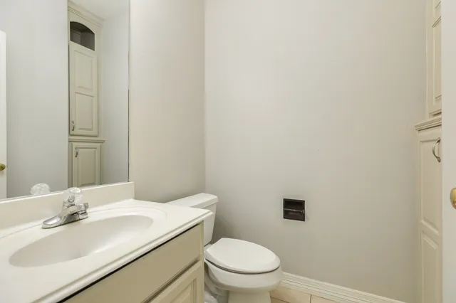 a bathroom with a toilet a sink and mirror