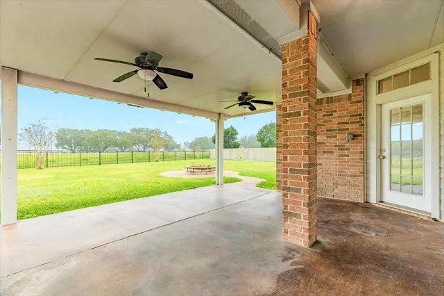 a view of a house with a backyard porch and sitting area