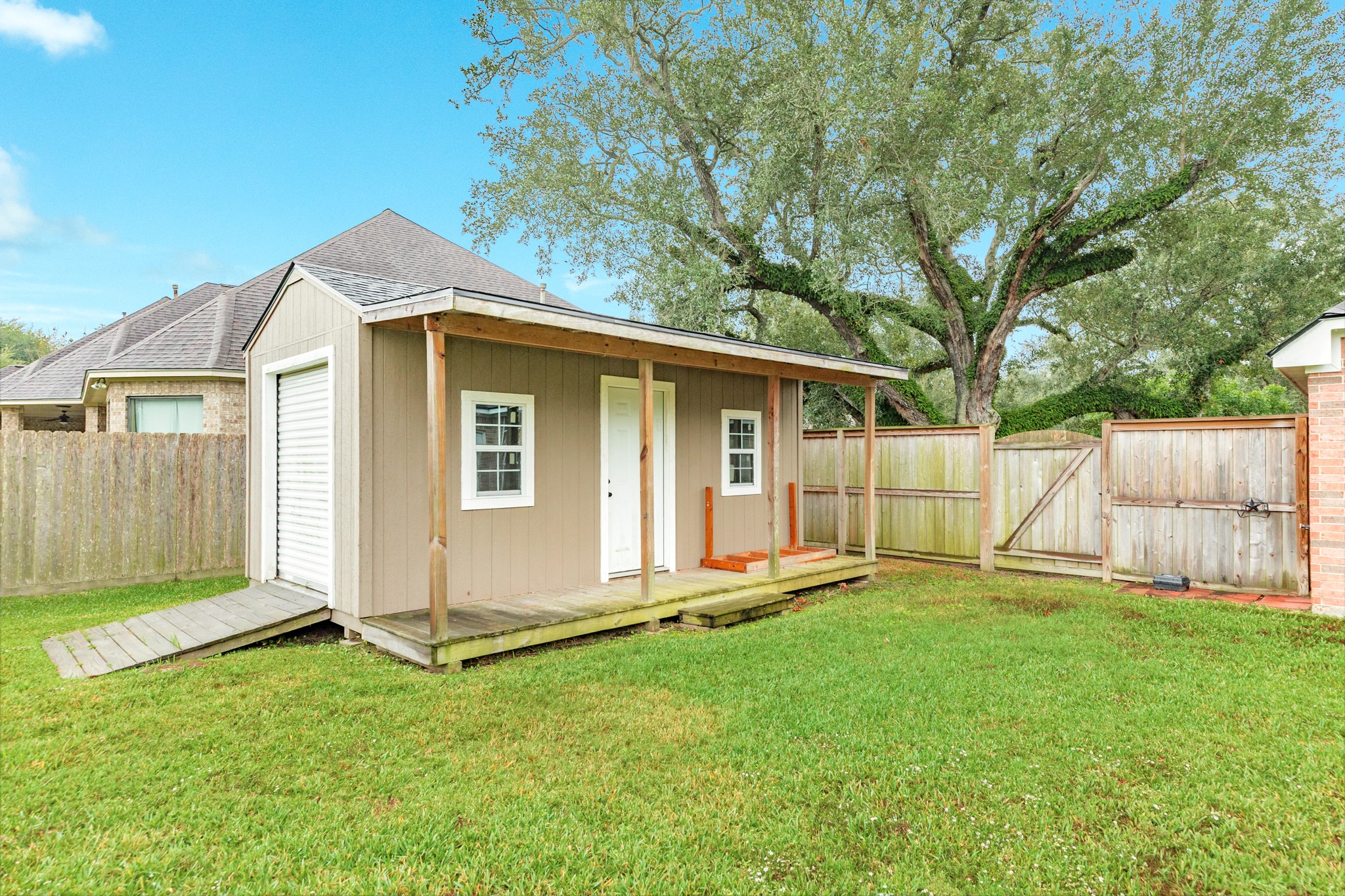 900 Enchanted Oaks Drive Angleton, TX 77515 - Photo 36 of 36 a front view of a house with a yard and fence