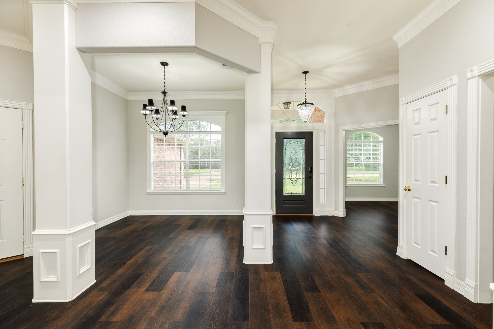 900 Enchanted Oaks Drive Angleton, TX 77515 - Photo 6 of 36 a view of a room with wooden floors and chandelier