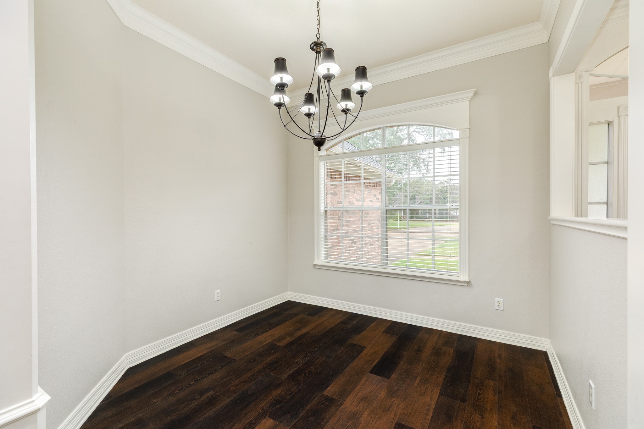 900 Enchanted Oaks Drive Angleton, TX 77515 - Photo 7 of 36 a view of an empty room with wooden floor and a window