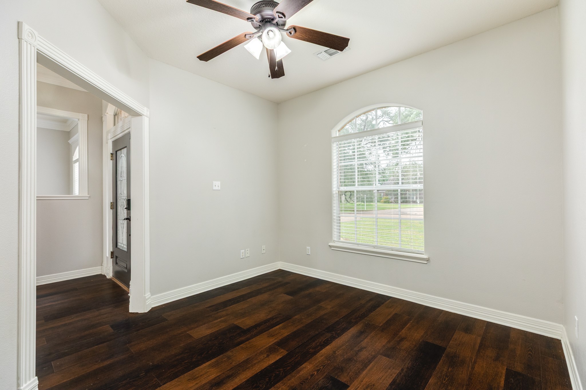900 Enchanted Oaks Drive Angleton, TX 77515 - Photo 8 of 36 a view of an empty room with wooden floor and a window