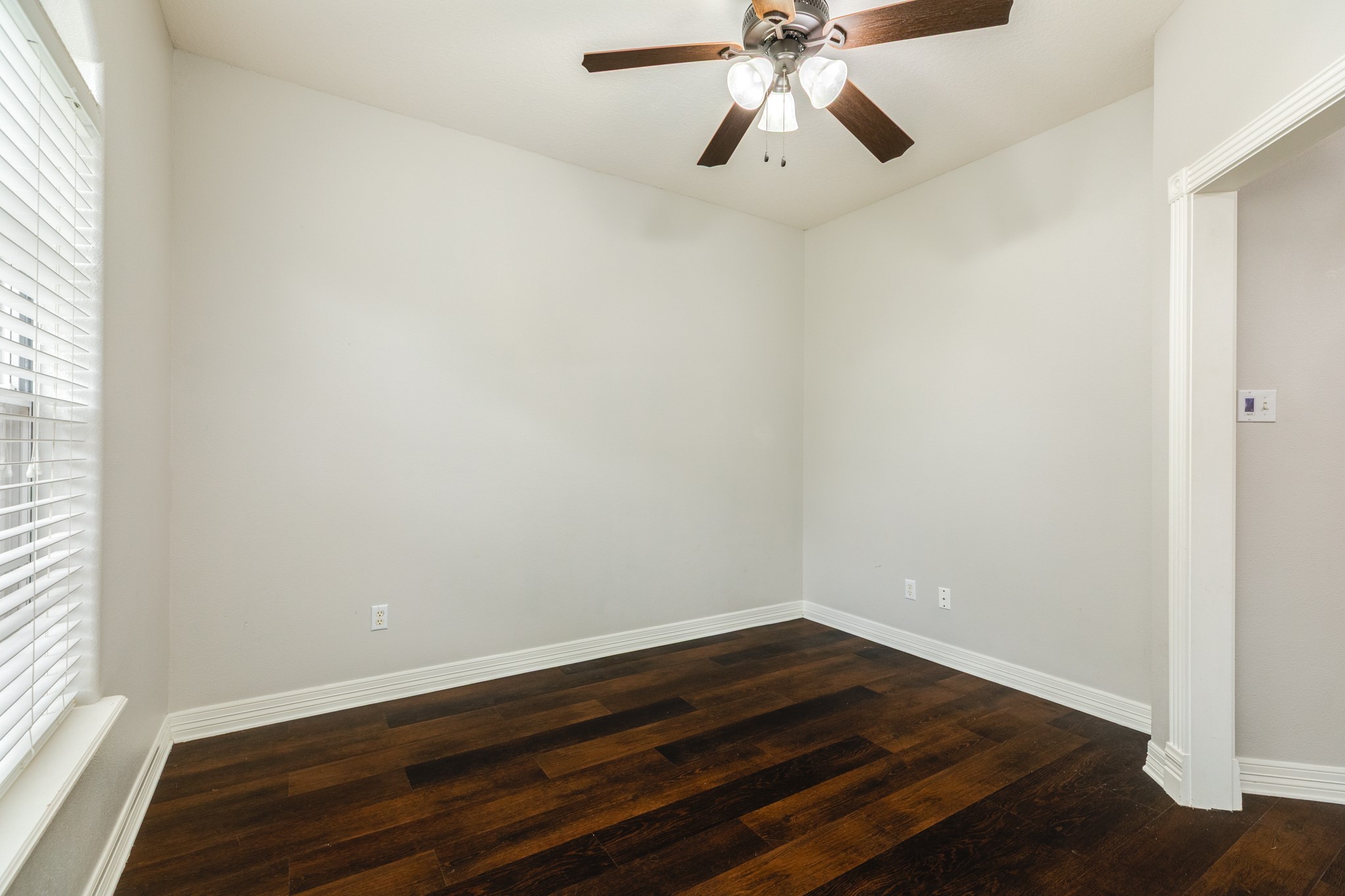 900 Enchanted Oaks Drive Angleton, TX 77515 - Photo 9 of 36 wooden floor in an empty room with a window