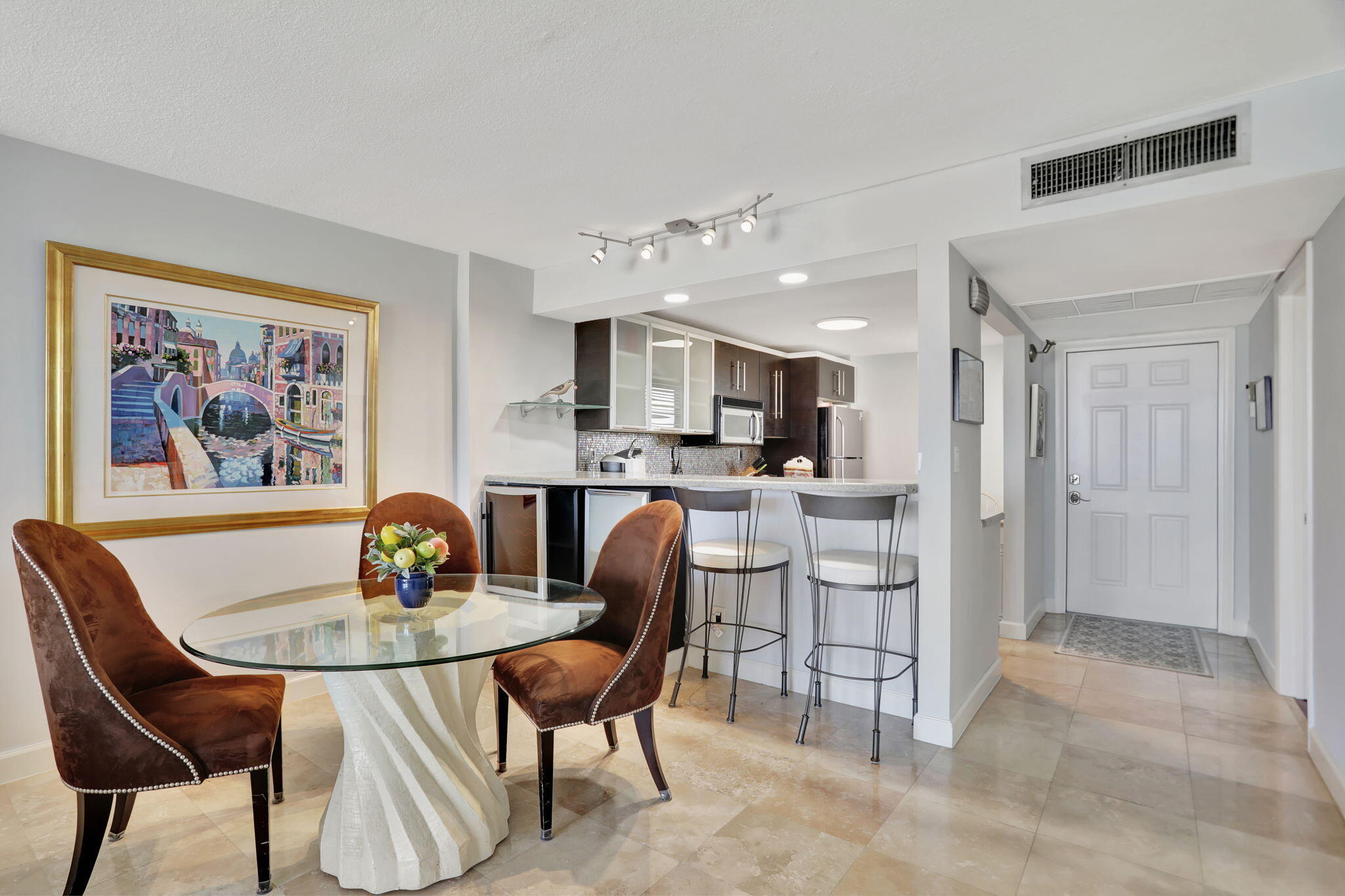 4 Royal Palm Way, Unit 6020 Boca Raton, FL 33432 - Photo 12 of 41 a kitchen with a dining table chairs and refrigerator