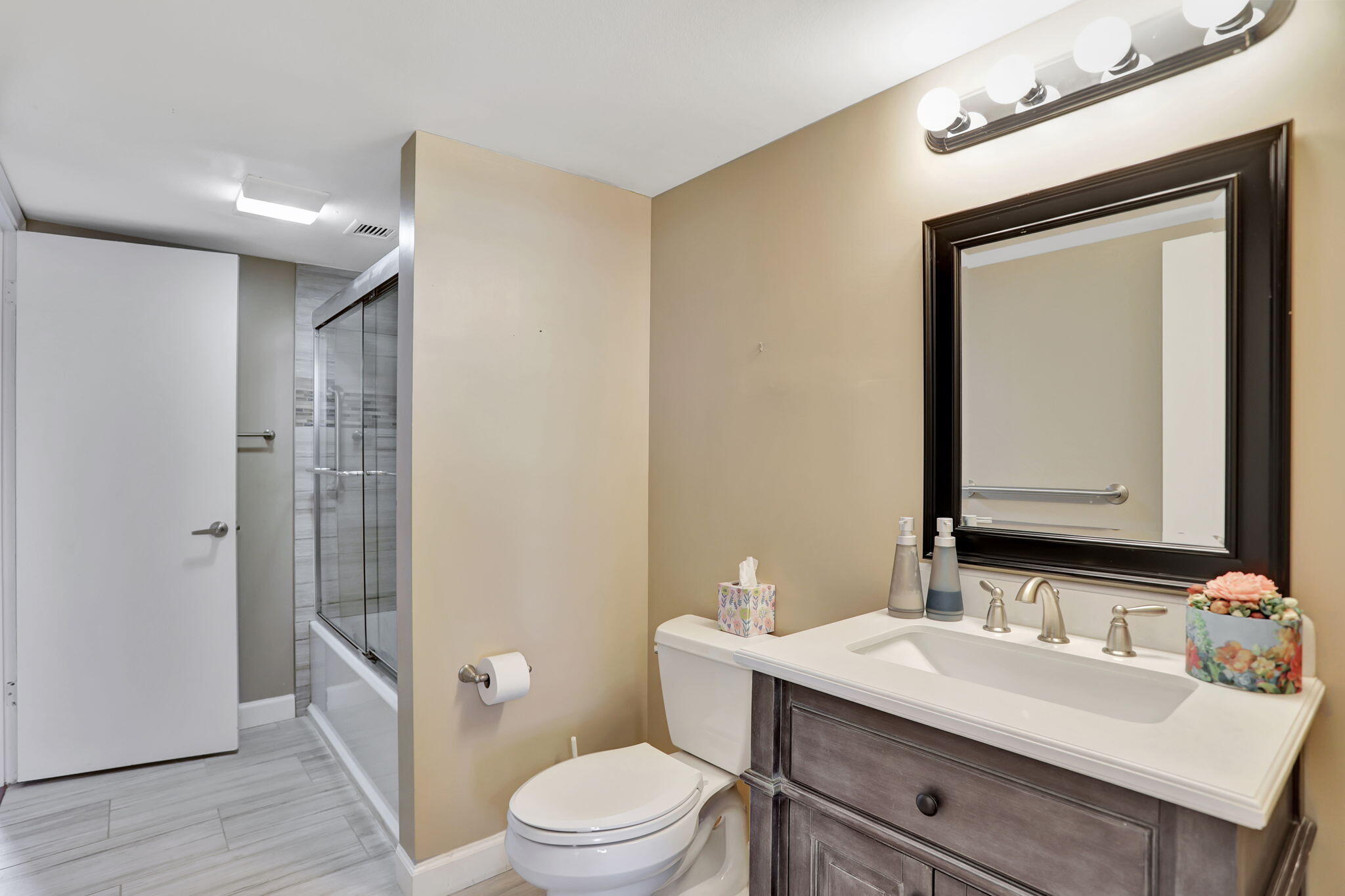4 Royal Palm Way, Unit 6020 Boca Raton, FL 33432 - Photo 21 of 41 a bathroom with a sink a toilet a mirror and shower