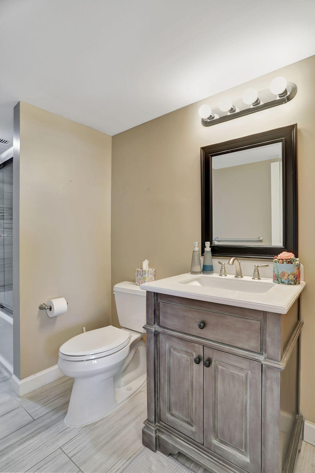 4 Royal Palm Way, Unit 6020 Boca Raton, FL 33432 - Photo 22 of 41 a bathroom with a granite countertop sink a toilet and a mirror