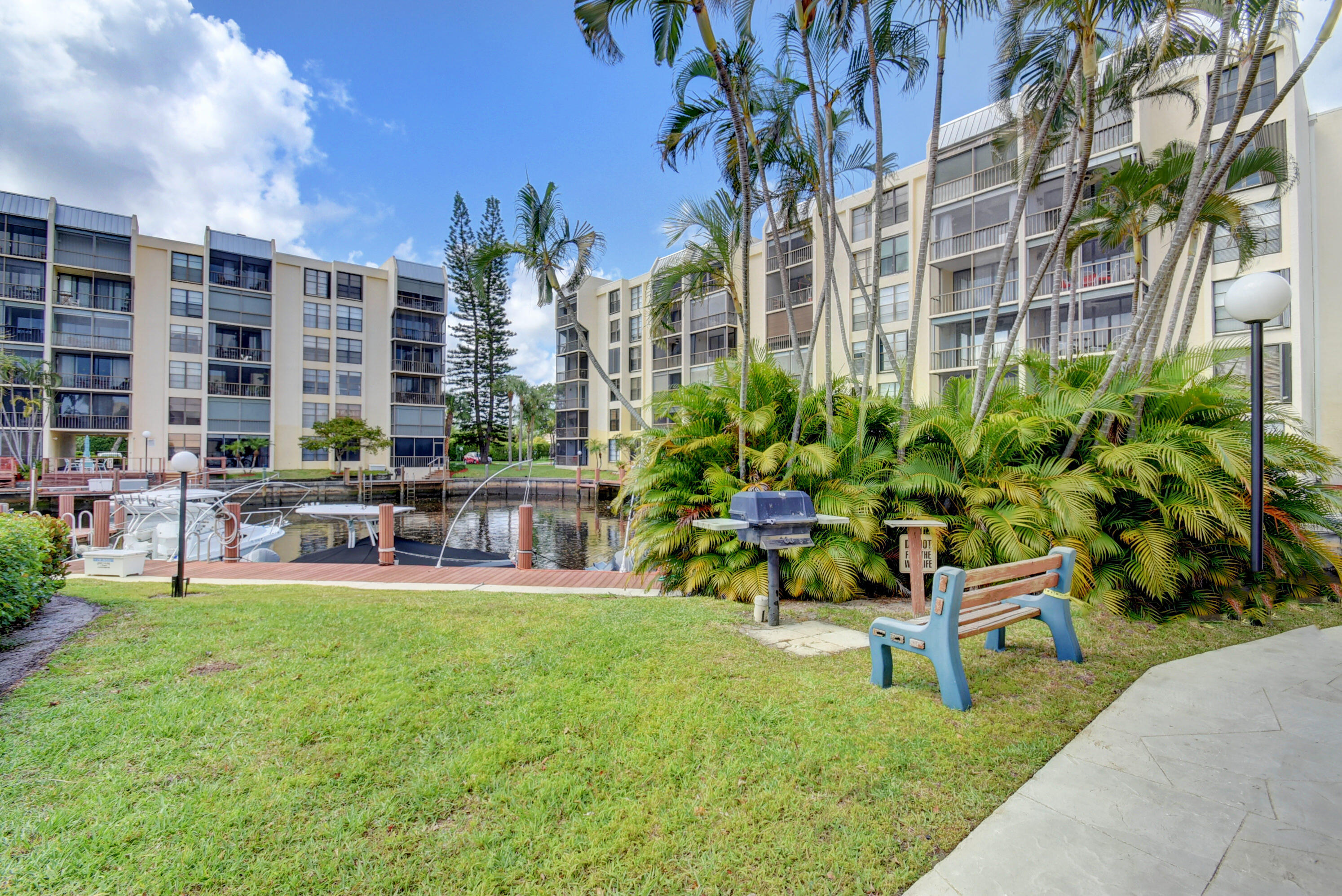4 Royal Palm Way, Unit 6020 Boca Raton, FL 33432 - Photo 31 of 41 a swimming pool with outdoor seating and yard
