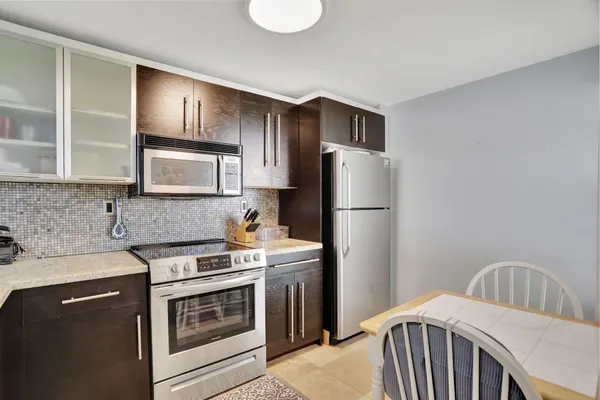 a kitchen with stainless steel appliances a refrigerator stove microwave and sink